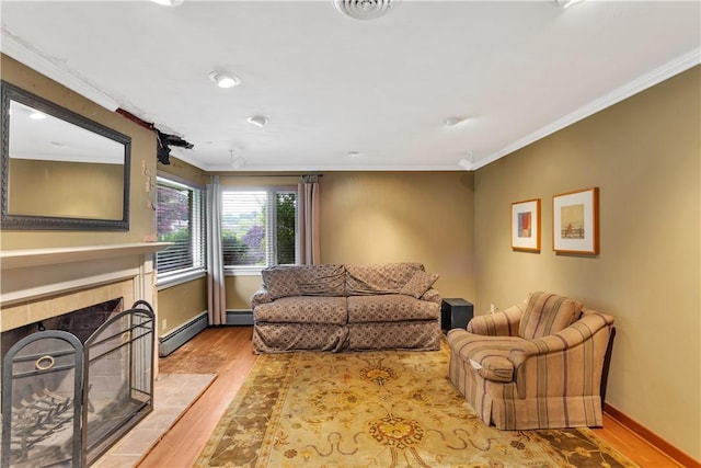 326 Pinevue Dr, Monroeville, PA 15146 - living room with ornamental molding, wood finished floors, a tiled fireplace, baseboards, and a baseboard radiator