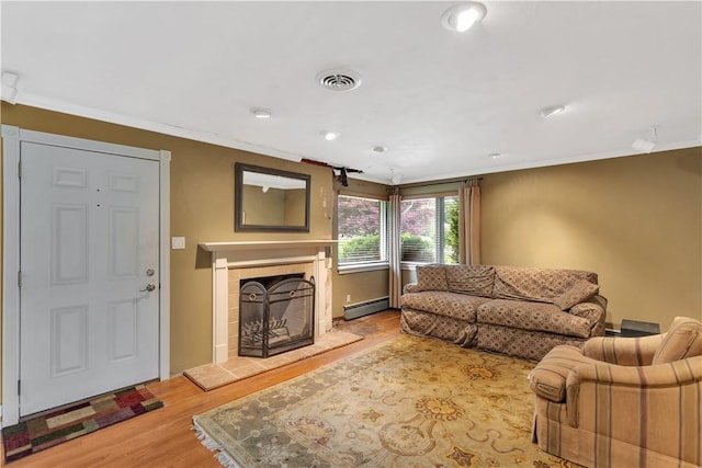 326 Pinevue Dr, Monroeville, PA 15146 - living room featuring a fireplace, baseboard heating, wood finished floors, ornamental molding, and recessed lighting