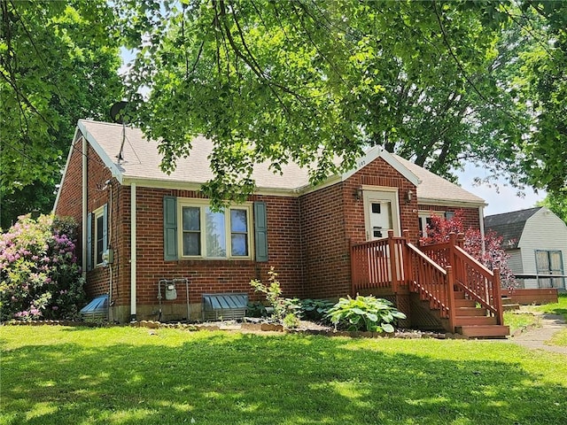 145 7th St, E Butler Boro, PA 16029 - view of front of property featuring brick siding, a front lawn, and roof with shingles