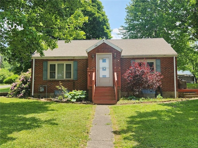 145 7th St, E Butler Boro, PA 16029 - bungalow-style house featuring a front lawn, brick siding, and a shingled roof