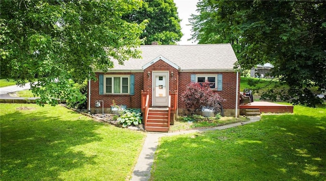 145 7th St, E Butler Boro, PA 16029 - bungalow with a front yard, roof with shingles, and brick siding