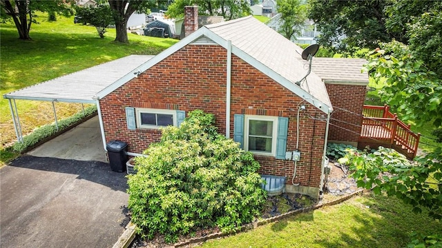 145 7th St, E Butler Boro, PA 16029 - view of side of home featuring a lawn, driveway, brick siding, and a deck