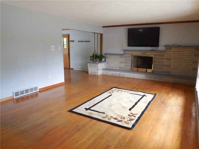 1118 Fairlane Dr, Hopewell Twp Bea, PA 15001 - unfurnished living room with a fireplace, wood finished floors, and baseboards