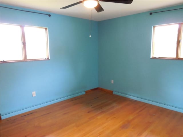 1118 Fairlane Dr, Hopewell Twp Bea, PA 15001 - empty room featuring a ceiling fan, baseboard heating, a baseboard heating unit, light wood-type flooring, and baseboards