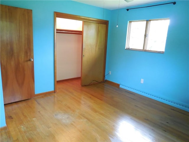 1118 Fairlane Dr, Hopewell Twp Bea, PA 15001 - unfurnished bedroom with wood finished floors, a closet, baseboards, and a baseboard radiator