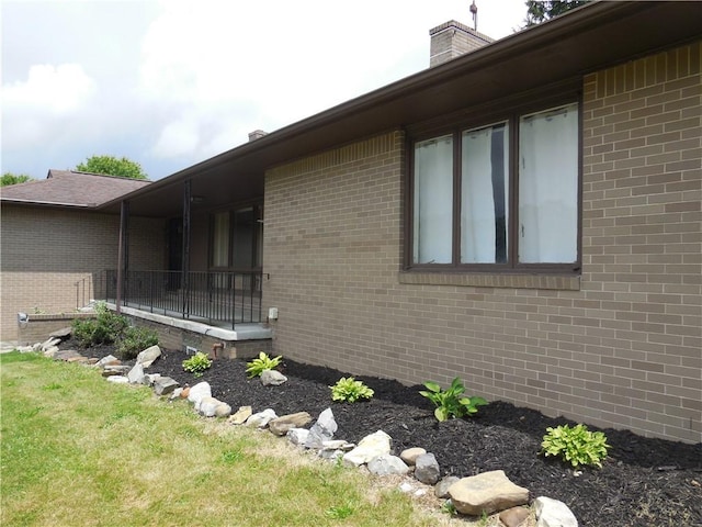 1118 Fairlane Dr, Hopewell Twp Bea, PA 15001 - view of property exterior featuring a chimney and brick siding