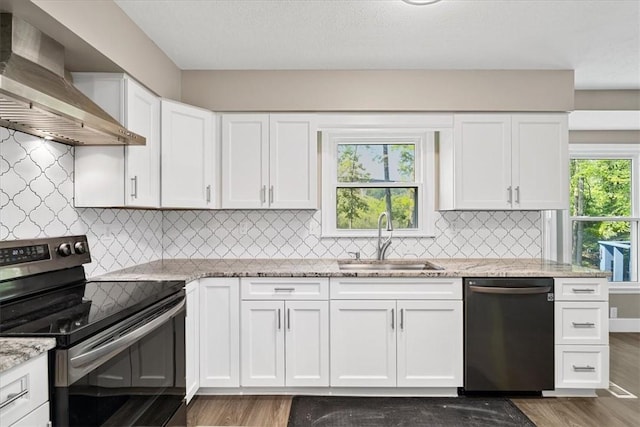 14 Laurel Hill Rd, Cecil, PA 15057 - kitchen with appliances with stainless steel finishes, wall chimney exhaust hood, a sink, and wood finished floors