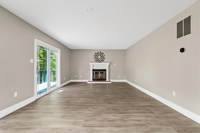 14 Laurel Hill Rd, Cecil, PA 15057 - unfurnished living room with baseboards, a glass covered fireplace, and wood finished floors
