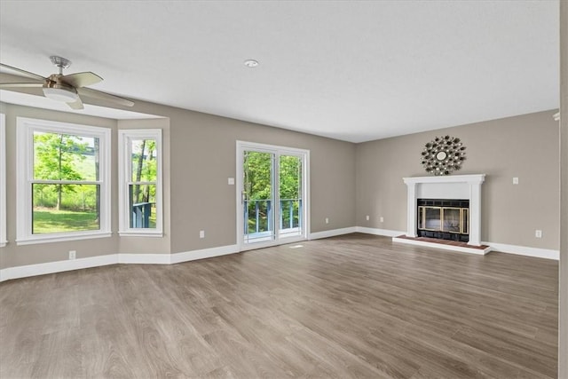 14 Laurel Hill Rd, Cecil, PA 15057 - unfurnished living room featuring healthy amount of natural light, baseboards, a glass covered fireplace, and wood finished floors