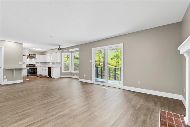 14 Laurel Hill Rd, Cecil, PA 15057 - unfurnished living room featuring baseboards, light wood-type flooring, ceiling fan, and a sink