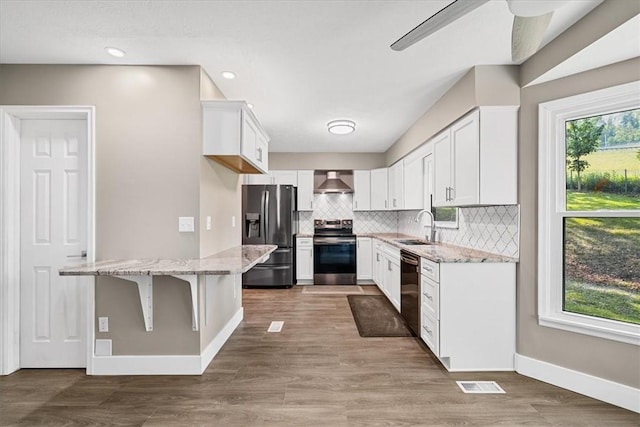 14 Laurel Hill Rd, Cecil, PA 15057 - kitchen with stainless steel appliances, a sink, wall chimney exhaust hood, white cabinets, and plenty of natural light