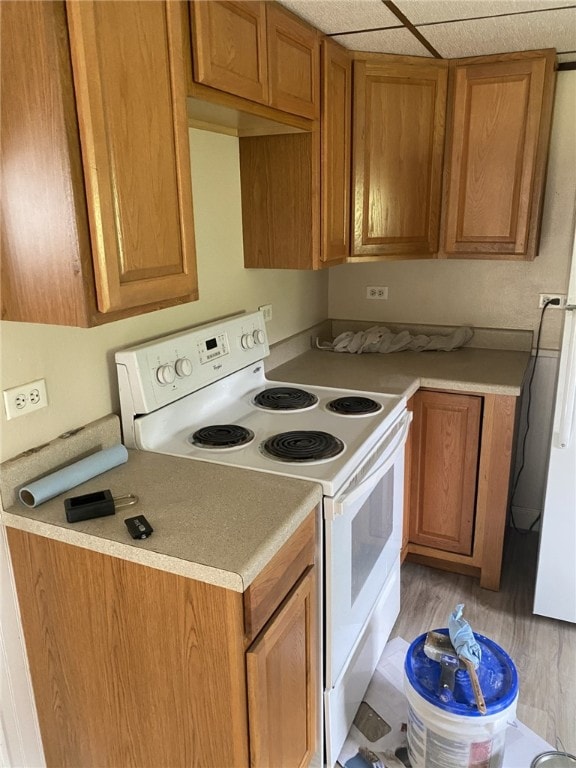 553-555 Steel Ave, Hempfield Twp Wml, PA 15635 - kitchen featuring electric stove, brown cabinetry, light countertops, and light wood-type flooring