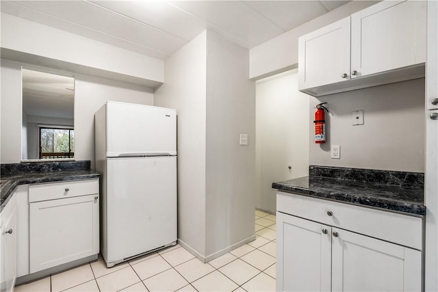 2034 Swallow Hill Rd Unit 403, Pittsburgh, PA 15220 - kitchen with freestanding refrigerator, white cabinetry, dark stone counters, and light tile patterned floors