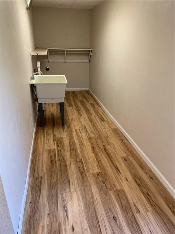 1464 State Route 819, Salem Twp Wml, PA 15601 - laundry room with light wood-type flooring, baseboards, and a sink