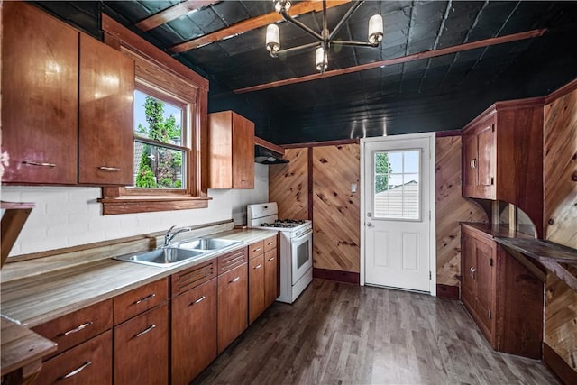 10 Amherst Ave, West View, PA 15229 - kitchen featuring white range with gas stovetop, a sink, healthy amount of natural light, dark wood-style flooring, and wood walls