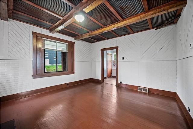 10 Amherst Ave, West View, PA 15229 - unfurnished room with hardwood / wood-style flooring, baseboards, brick wall, and beam ceiling
