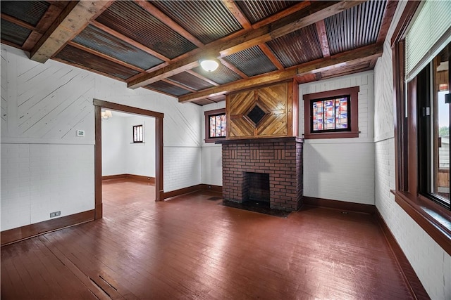 10 Amherst Ave, West View, PA 15229 - unfurnished living room featuring baseboards, wood-type flooring, a brick fireplace, and beamed ceiling