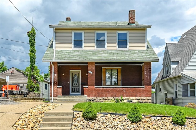 10 Amherst Ave, West View, PA 15229 - view of front facade featuring brick siding, a porch, and a chimney