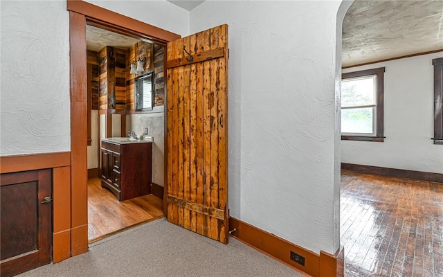 10 Amherst Ave, West View, PA 15229 - hallway with a sink, wood finished floors, a textured wall, and arched walkways