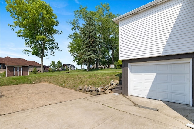 11660 Dennis Cir N, Huntingdon, PA 15642 - view of green lawn with concrete driveway, an attached garage, and a residential view