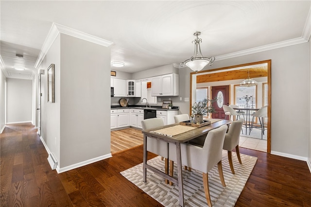 11660 Dennis Cir N, Huntingdon, PA 15642 - dining space with crown molding, dark wood-type flooring, baseboards, and a chandelier