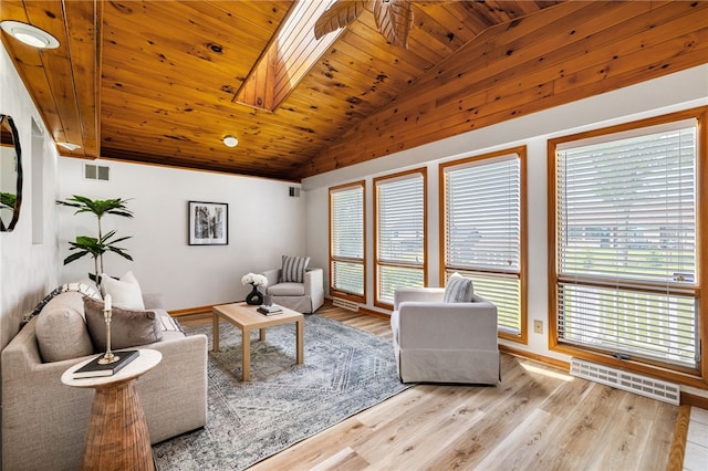 11660 Dennis Cir N, Huntingdon, PA 15642 - living area featuring vaulted ceiling, wooden ceiling, light wood-type flooring, a skylight, and baseboards
