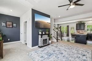 139 Moyer Hl, Cranberry Twp, PA 16066 - living room featuring ceiling fan, baseboards, stairs, and a fireplace