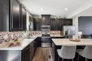 139 Moyer Hl, Cranberry Twp, PA 16066 - kitchen with stainless steel appliances, tasteful backsplash, a center island, a breakfast bar area, and a sink
