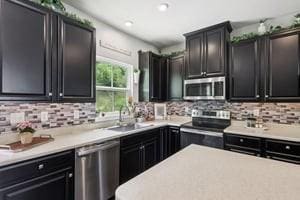 139 Moyer Hl, Cranberry Twp, PA 16066 - kitchen featuring stainless steel appliances, tasteful backsplash, dark cabinetry, and recessed lighting