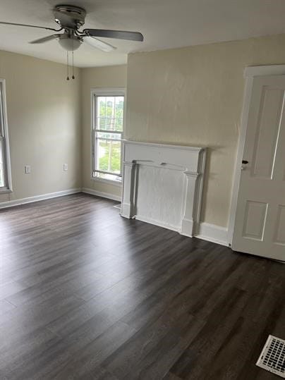 551-555 New Alexandria Rd, Hempfield Twp Wml, PA 15601 - unfurnished living room featuring a ceiling fan, dark wood-style flooring, and baseboards