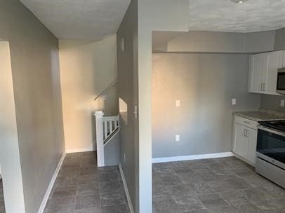 551-555 New Alexandria Rd, Hempfield Twp Wml, PA 15601 - kitchen featuring stainless steel appliances, white cabinetry, baseboards, and stone finish flooring