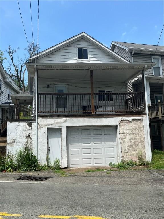 551-555 New Alexandria Rd, Hempfield Twp Wml, PA 15601 - view of property exterior with a garage, a balcony, and driveway