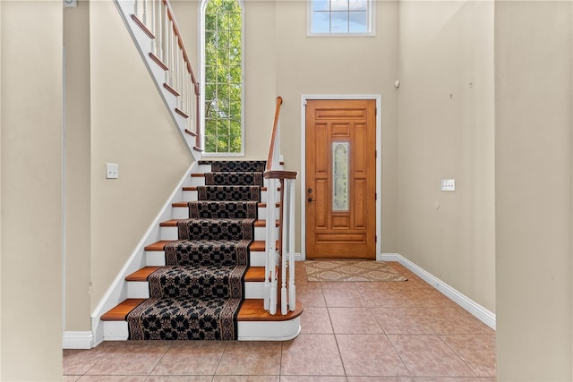 621 Columbia Ct, Adams Twp, PA 16046 - foyer featuring baseboards, stairway, a towering ceiling, and tile patterned flooring
