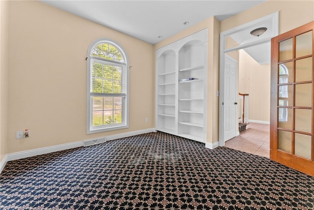 621 Columbia Ct, Adams Twp, PA 16046 - tiled empty room with baseboards and built in shelves