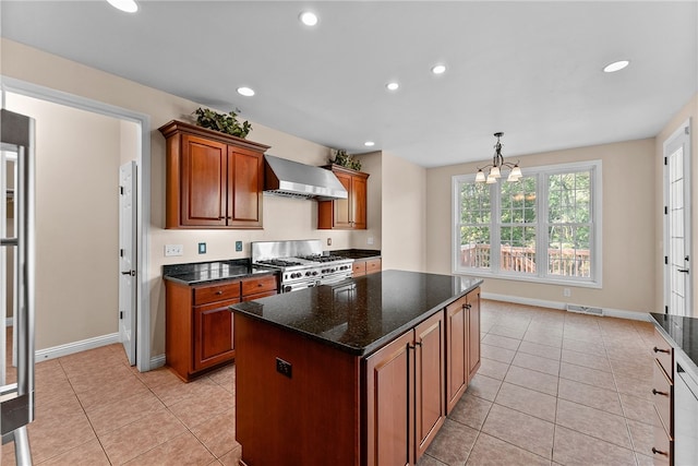 621 Columbia Ct, Adams Twp, PA 16046 - kitchen featuring high end stainless steel range, wall chimney exhaust hood, recessed lighting, light tile patterned floors, and a center island