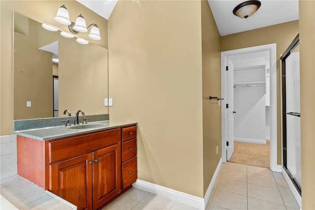 621 Columbia Ct, Adams Twp, PA 16046 - bathroom with vanity, a walk in closet, tile patterned floors, and baseboards
