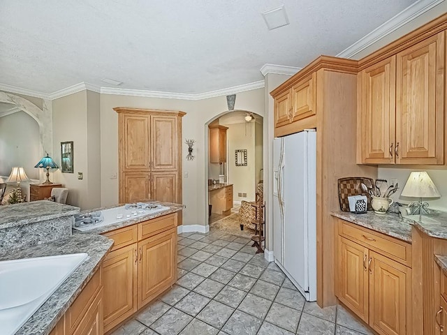 210 Adams Pointe Blvd Unit 6, Adams Twp, PA 16046 - kitchen with white fridge with ice dispenser, arched walkways, ornamental molding, light stone counters, and a sink