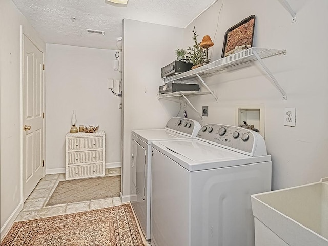 210 Adams Pointe Blvd Unit 6, Adams Twp, PA 16046 - washroom featuring washing machine and clothes dryer, a textured ceiling, and baseboards