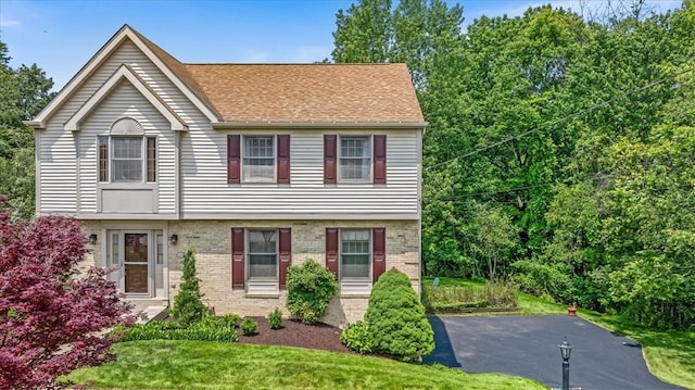 8963 Seneca Ave, Mccandless, PA 15237 - view of front of home featuring brick siding, a front yard, and roof with shingles