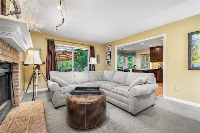 8963 Seneca Ave, Mccandless, PA 15237 - carpeted living room with a brick fireplace, baseboards, and track lighting