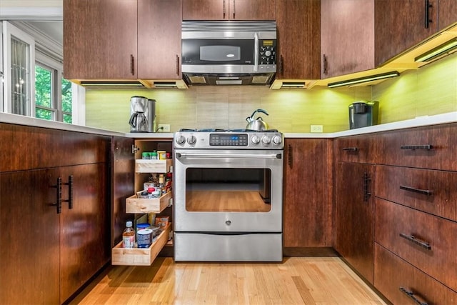 8963 Seneca Ave, Mccandless, PA 15237 - kitchen with appliances with stainless steel finishes, light wood-type flooring, and decorative backsplash