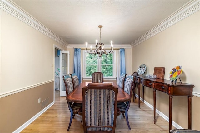 8963 Seneca Ave, Mccandless, PA 15237 - dining area featuring a chandelier, ornamental molding, baseboards, and light wood-style flooring