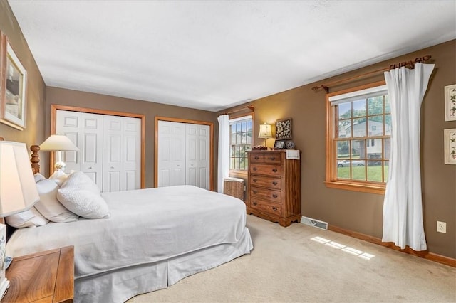 8963 Seneca Ave, Mccandless, PA 15237 - bedroom featuring multiple closets, baseboards, and light carpet