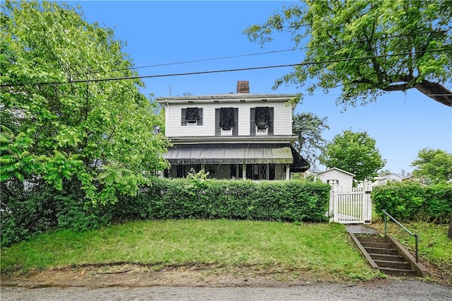 4605 2nd St, Versailles Boro, PA 15132 - view of front of house featuring a gate, a chimney, and a front lawn