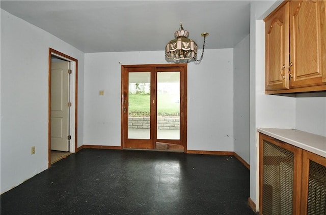 4605 2nd St, Versailles Boro, PA 15132 - unfurnished dining area with a chandelier, tile patterned floors, and baseboards