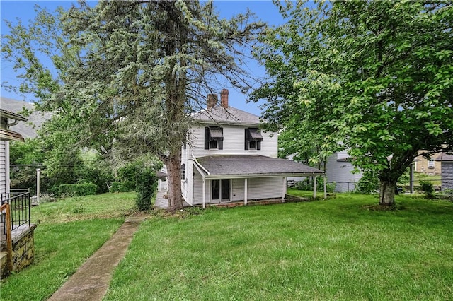 4605 2nd St, Versailles Boro, PA 15132 - back of property with a chimney and a lawn