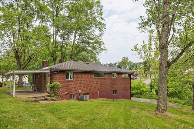 9830 Don Dr, North Huntingdon, PA 15642 - back of house with a chimney, a lawn, and central air condition unit