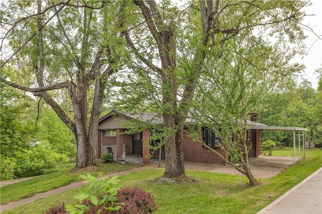 9830 Don Dr, North Huntingdon, PA 15642 - view of front facade with brick siding, a front lawn, and a chimney