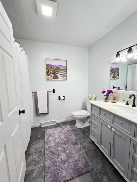 229 Chamberlain St, Allegheny Twp Wml, PA 15656 - full bathroom with vanity, toilet, baseboards, and a textured ceiling