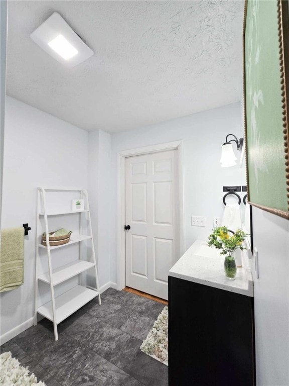 229 Chamberlain St, Allegheny Twp Wml, PA 15656 - bathroom with vanity, baseboards, and a textured ceiling